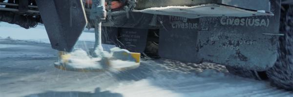 Photo: Vince Franke Snow plow dispensing road salt on snowy road